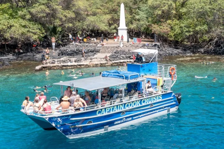 a boat floating along a river next to a body of water