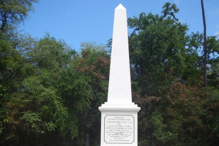 a clock tower in front of a tree